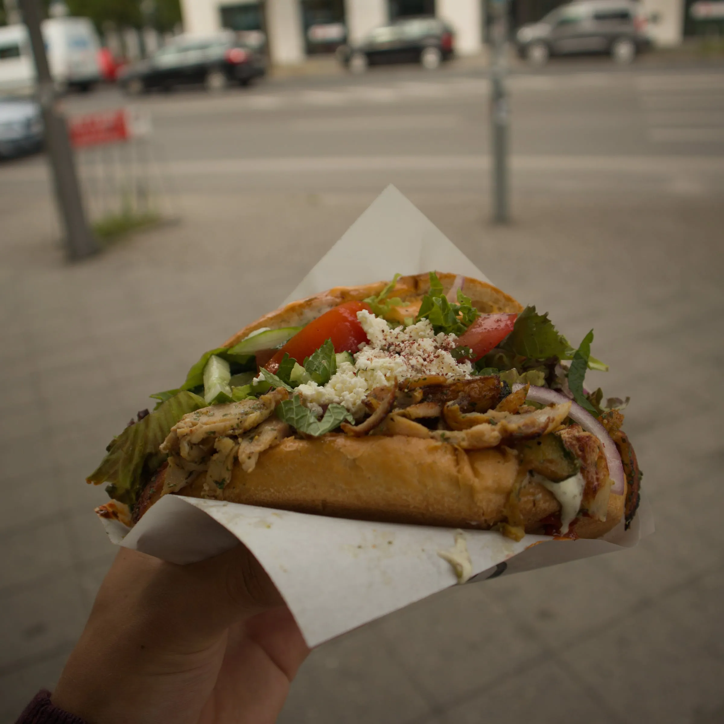 Close-up of traditional German pretzel and grilled sausage at a market stall