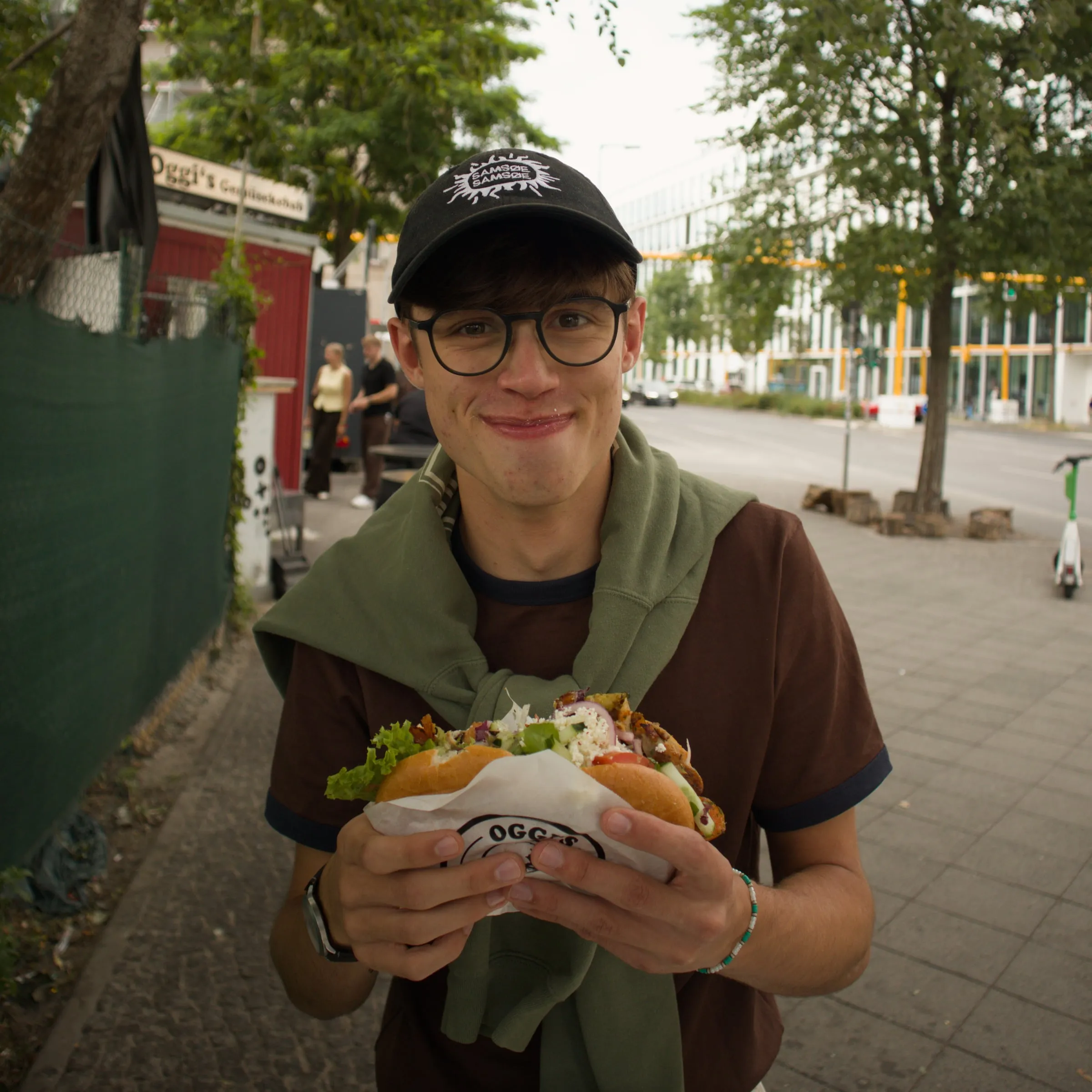 James sitting outside at a street cafe table